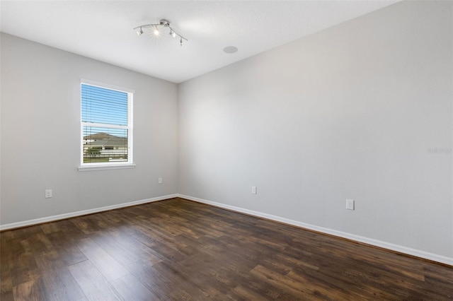 spare room with dark hardwood / wood-style flooring