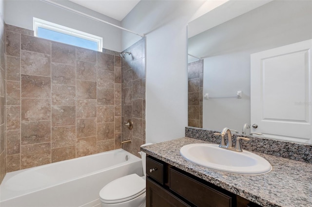 full bathroom featuring toilet, vanity, and tiled shower / bath