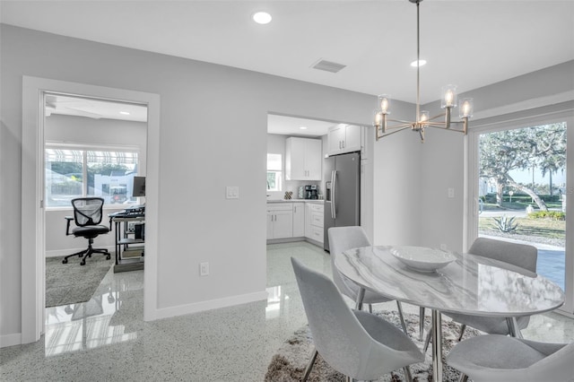 dining space with an inviting chandelier