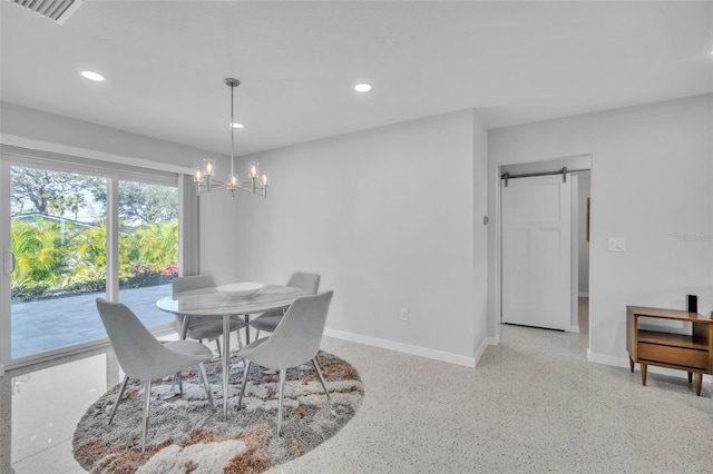 dining space with a barn door and a notable chandelier