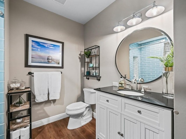 bathroom featuring vanity, hardwood / wood-style flooring, and toilet