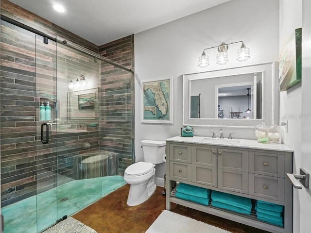 bathroom featuring vanity, toilet, and a shower with door