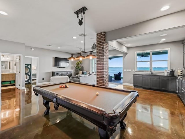 recreation room featuring sink, concrete floors, ornate columns, and billiards