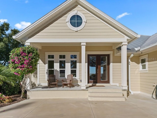 exterior space featuring a porch and french doors