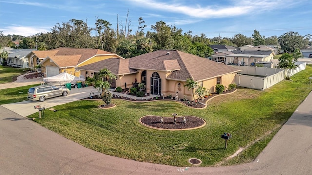 view of front of home featuring a garage and a front lawn