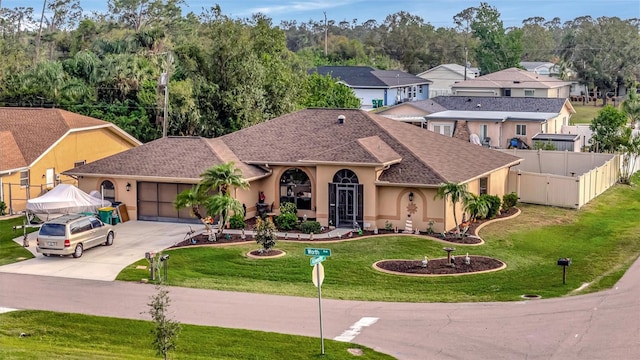 view of front of house featuring a garage and a front lawn