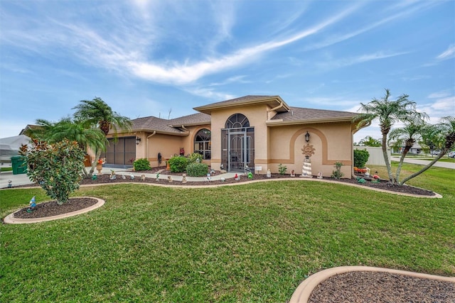 mediterranean / spanish home with a front lawn and a garage