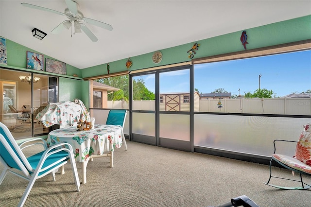 sunroom with ceiling fan and lofted ceiling