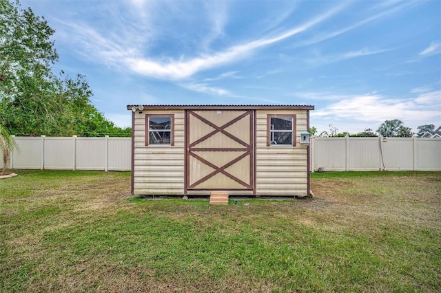 view of outdoor structure featuring a lawn