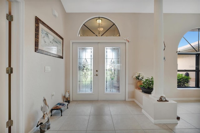 entrance foyer featuring french doors and light tile patterned floors