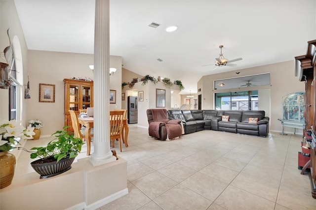 living room featuring lofted ceiling, ceiling fan, ornate columns, and light tile patterned floors