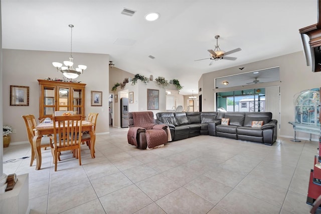 tiled living room with ceiling fan with notable chandelier and lofted ceiling