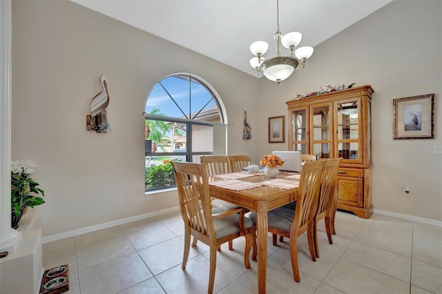 tiled dining area with vaulted ceiling and a notable chandelier