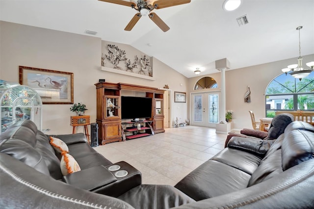 living room featuring light tile patterned floors, ceiling fan with notable chandelier, and vaulted ceiling