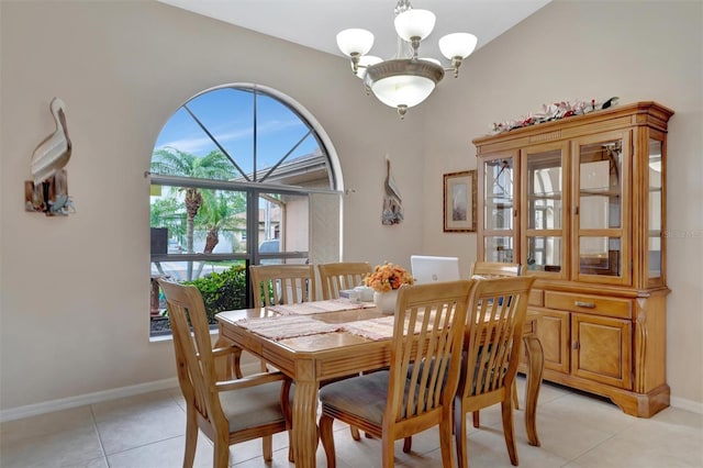 tiled dining area featuring an inviting chandelier