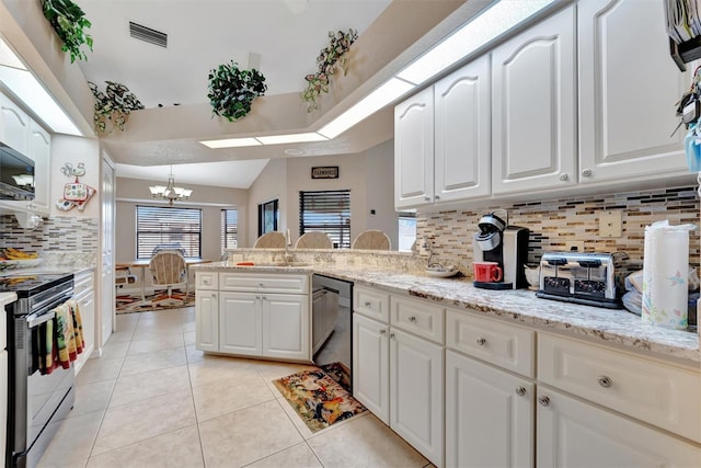 kitchen with tasteful backsplash, kitchen peninsula, white cabinets, and appliances with stainless steel finishes