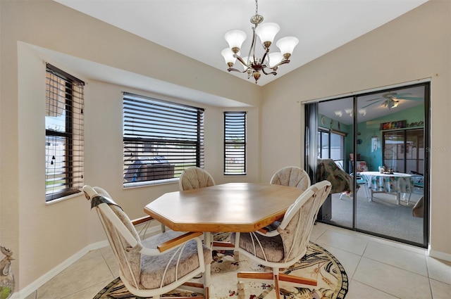 dining space with ceiling fan with notable chandelier, light tile patterned floors, and lofted ceiling