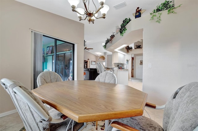 tiled dining room featuring lofted ceiling and ceiling fan with notable chandelier