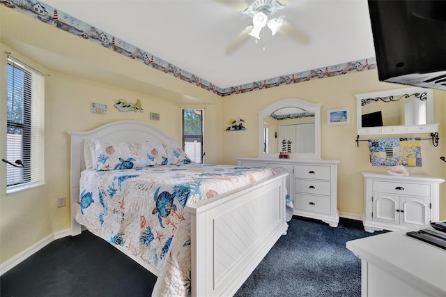 bedroom featuring ceiling fan and dark carpet