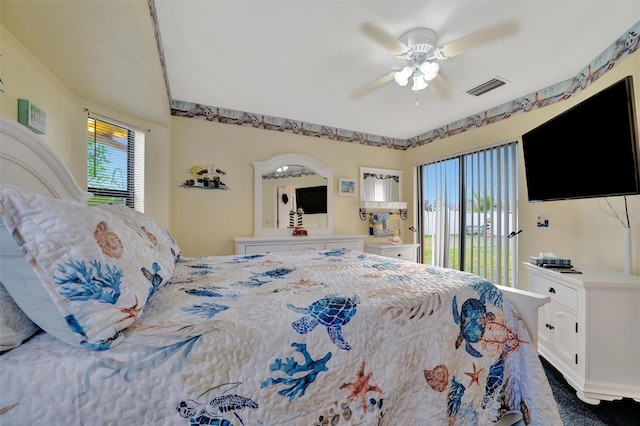 bedroom featuring multiple windows, access to outside, and ceiling fan