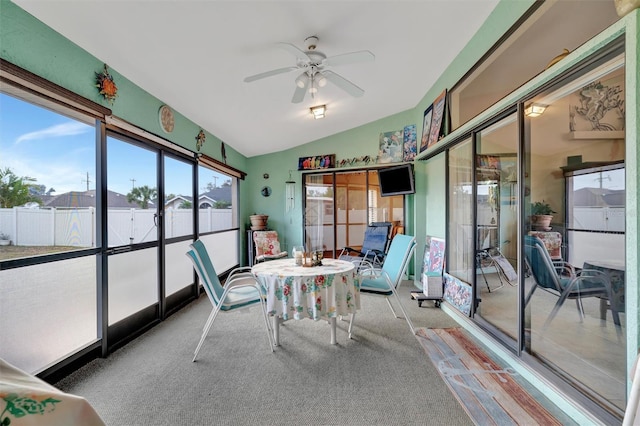 sunroom / solarium with ceiling fan and vaulted ceiling