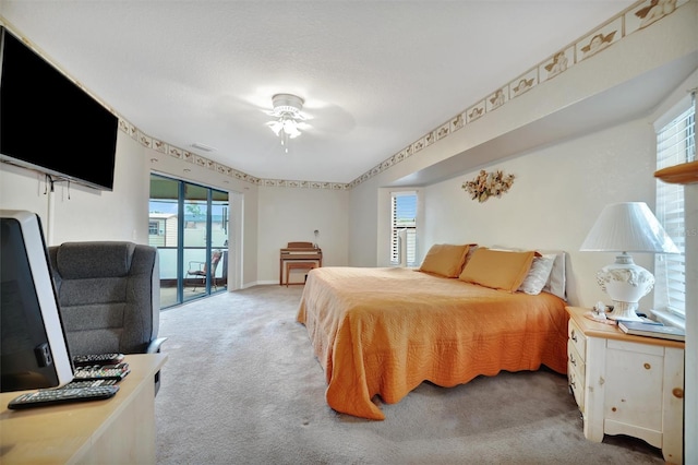 carpeted bedroom featuring access to exterior, ceiling fan, and multiple windows