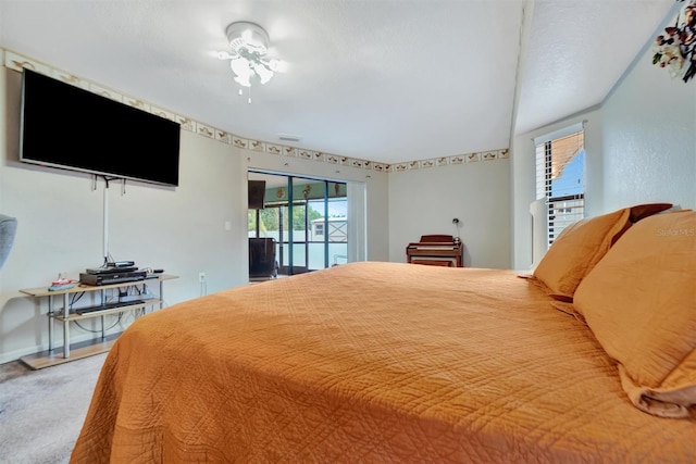 bedroom with carpet, access to outside, and multiple windows