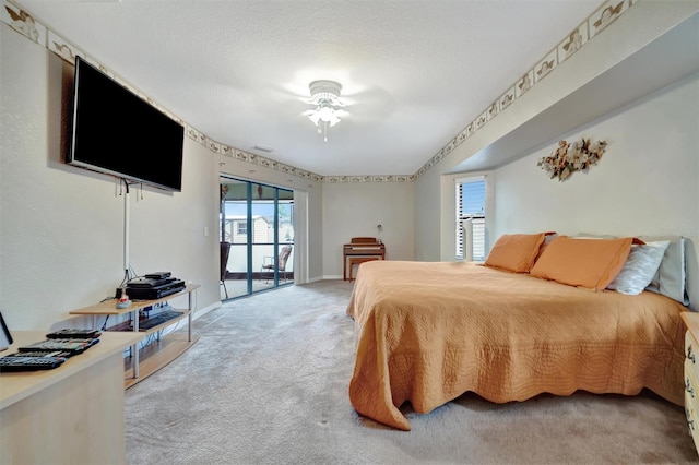 carpeted bedroom featuring access to exterior and ceiling fan