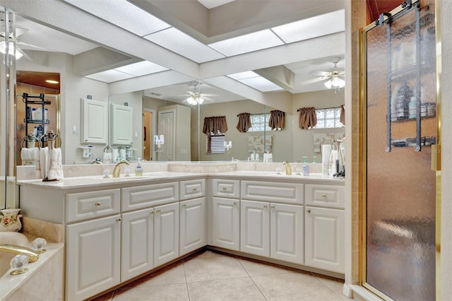 bathroom featuring tile patterned floors, vanity, and a shower with shower door