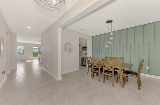 tiled dining area featuring beverage cooler