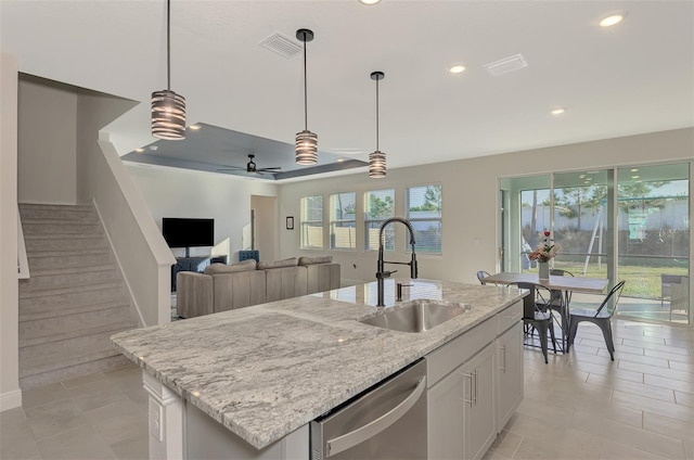 kitchen featuring white cabinetry, sink, dishwasher, ceiling fan, and a center island with sink