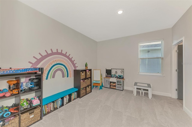 recreation room featuring light carpet