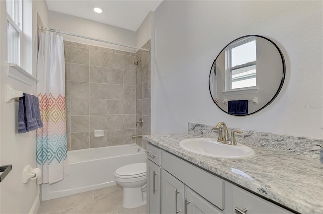 full bathroom with tile patterned flooring, vanity, shower / bath combo, and toilet