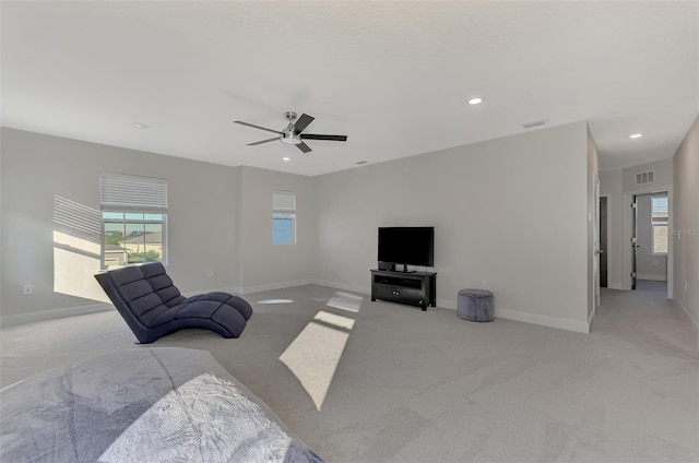 living room featuring ceiling fan and light colored carpet