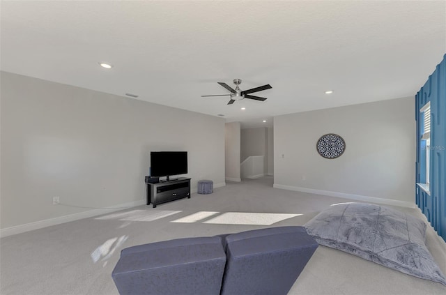 carpeted living room featuring a textured ceiling and ceiling fan