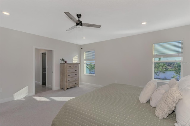 bedroom with ceiling fan and light colored carpet