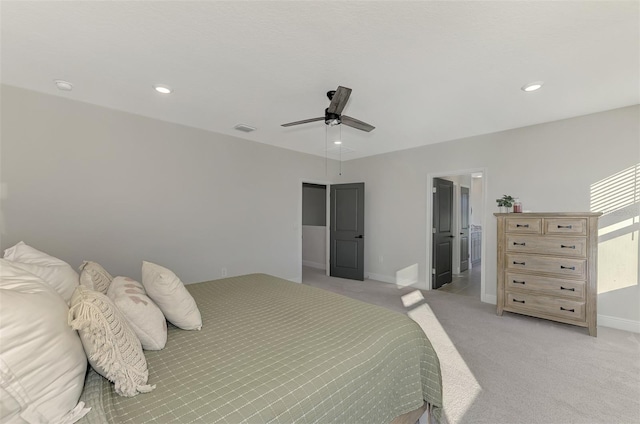 bedroom with ceiling fan and light colored carpet