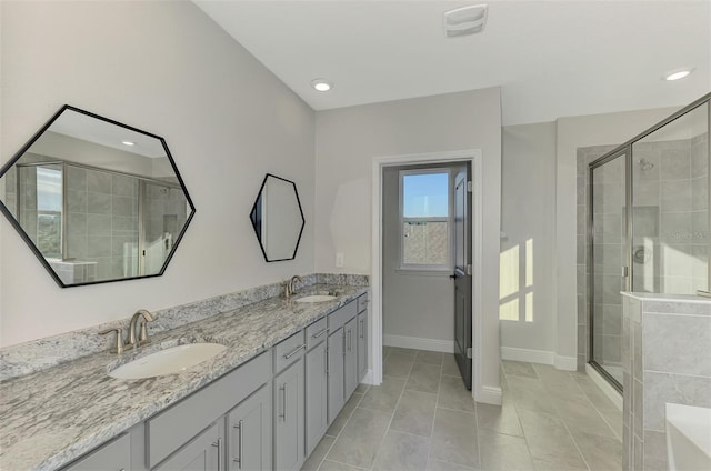 bathroom with tile patterned flooring, vanity, and walk in shower