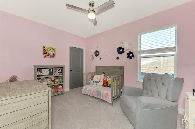 carpeted bedroom with ceiling fan and multiple windows