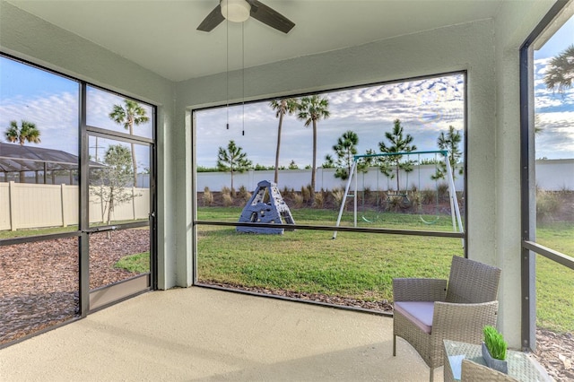 sunroom / solarium featuring ceiling fan