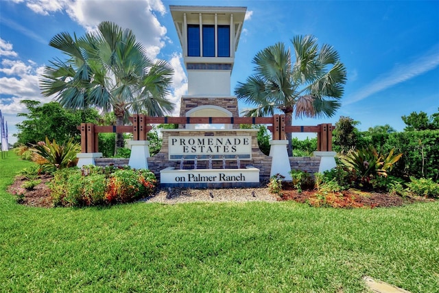 community sign featuring a lawn