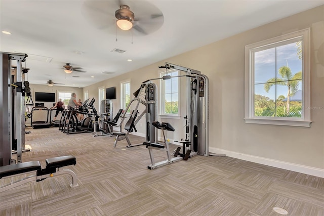 gym featuring ceiling fan and light colored carpet