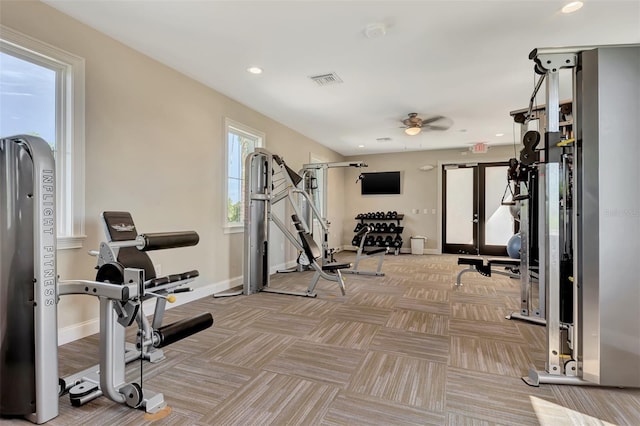 workout area with ceiling fan and a healthy amount of sunlight