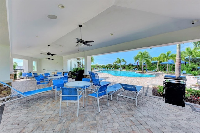 view of patio featuring ceiling fan and a community pool