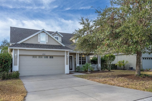 view of front of home featuring a porch and a garage