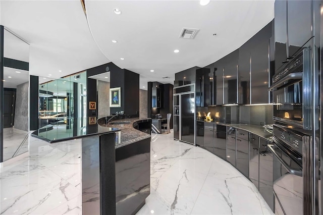 kitchen featuring built in fridge, marble finish floor, visible vents, modern cabinets, and dark stone counters