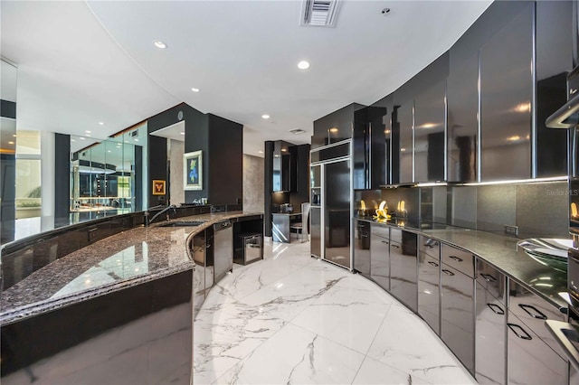 bathroom with recessed lighting, a sink, visible vents, marble finish floor, and decorative backsplash