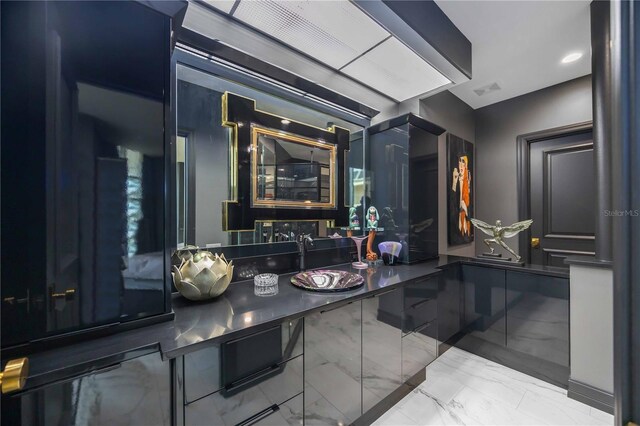 bathroom with recessed lighting, marble finish floor, and a sink