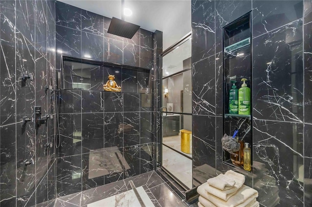 full bathroom featuring a walk in shower and tile walls