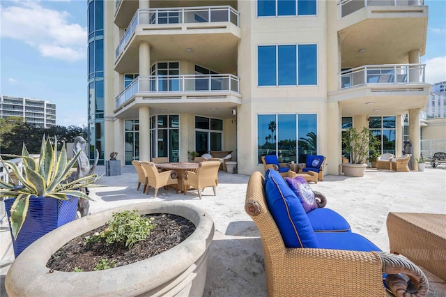 back of property featuring a patio area, an outdoor hangout area, and stucco siding